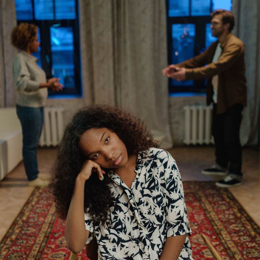 woman calmly stepping away from a heated group argument