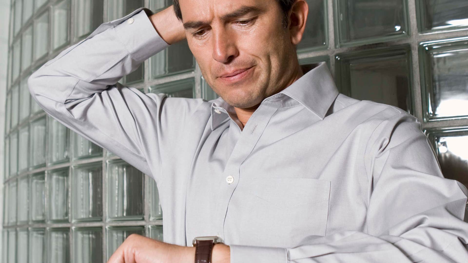 man looking at his watch to make sure he's early