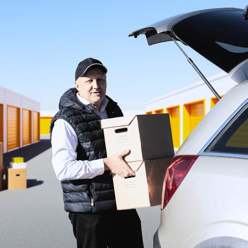 gen x man moving boxes into a storage unit