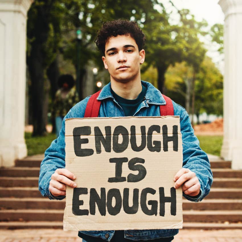 Younger man protesting against climate change outside. 