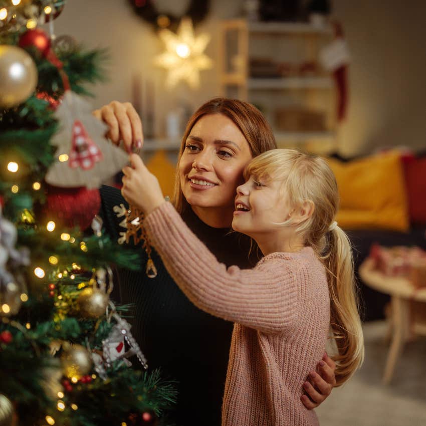 mom holding the same family holiday traditions with daughter