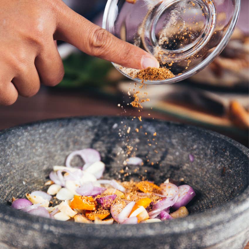 Person seasoning food with simple inexpensive seasonings