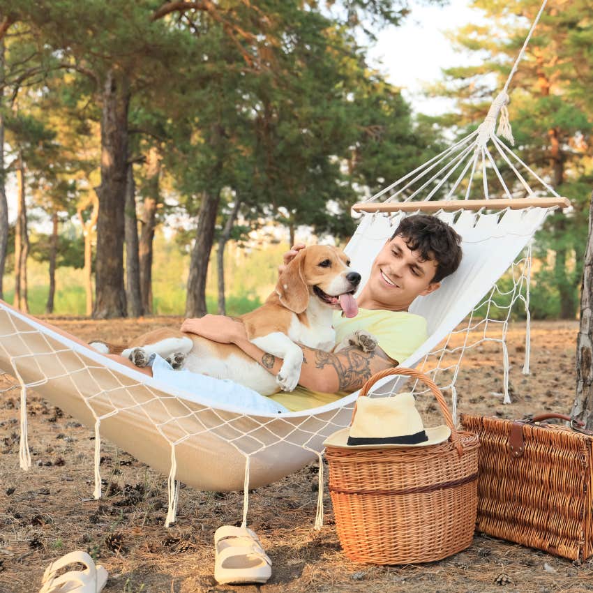man in a hammock with his dog treating his weekend like it's a vacation
