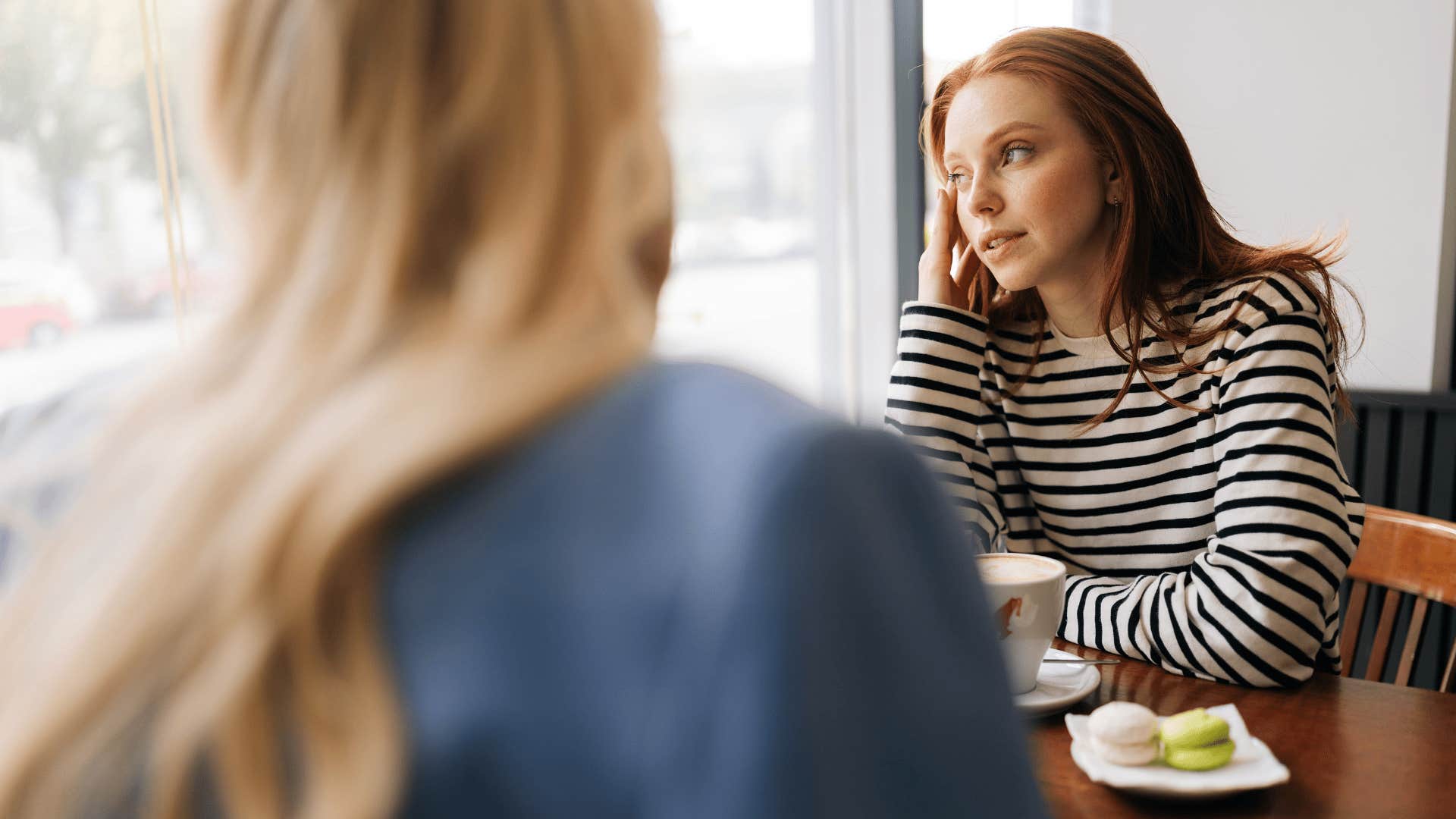 unbothered woman talking to friend telling her believe what you want