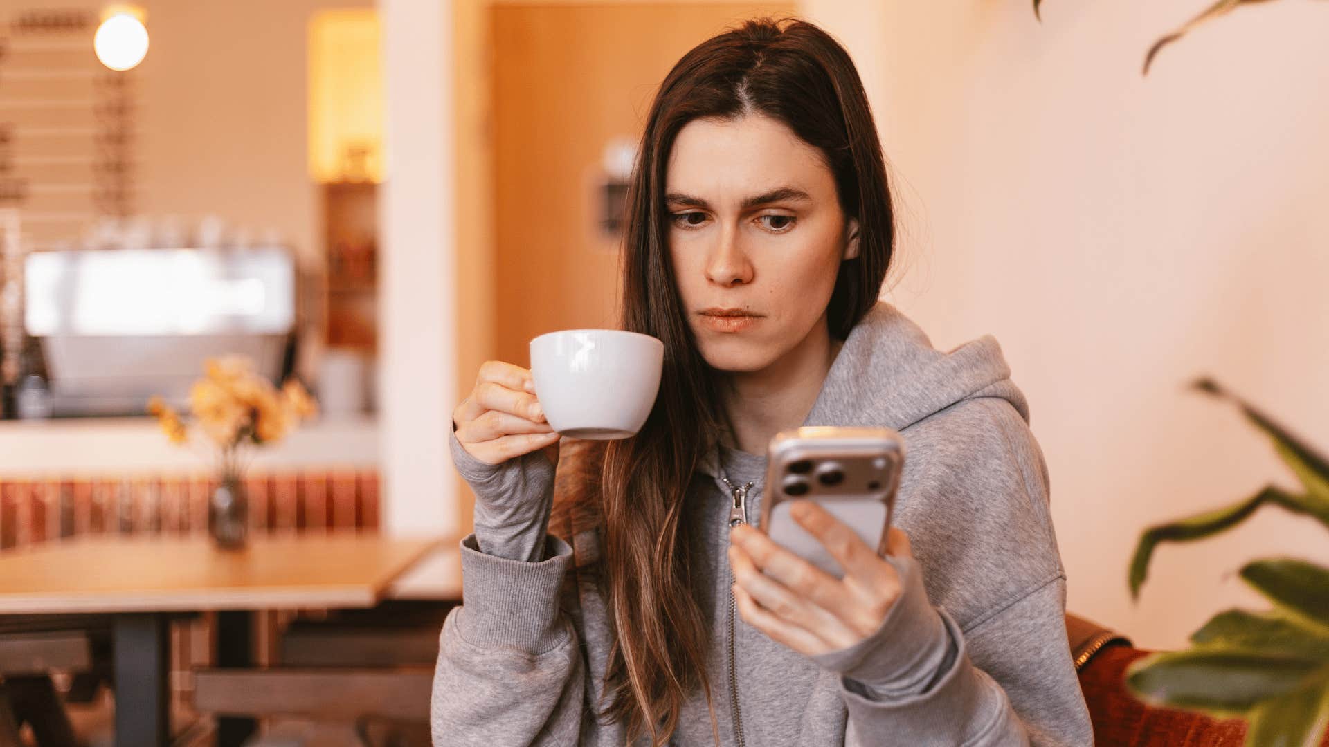 unbothered woman who doesn't care what others think looking at her phone