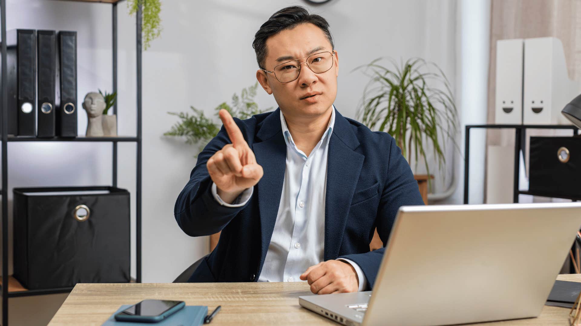 man at work waving his finger saying not interested