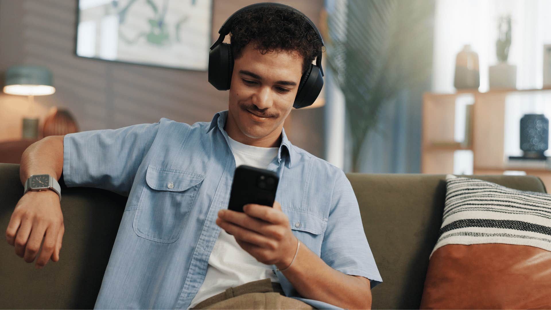 man in white shirt and headphones listening to podcasts