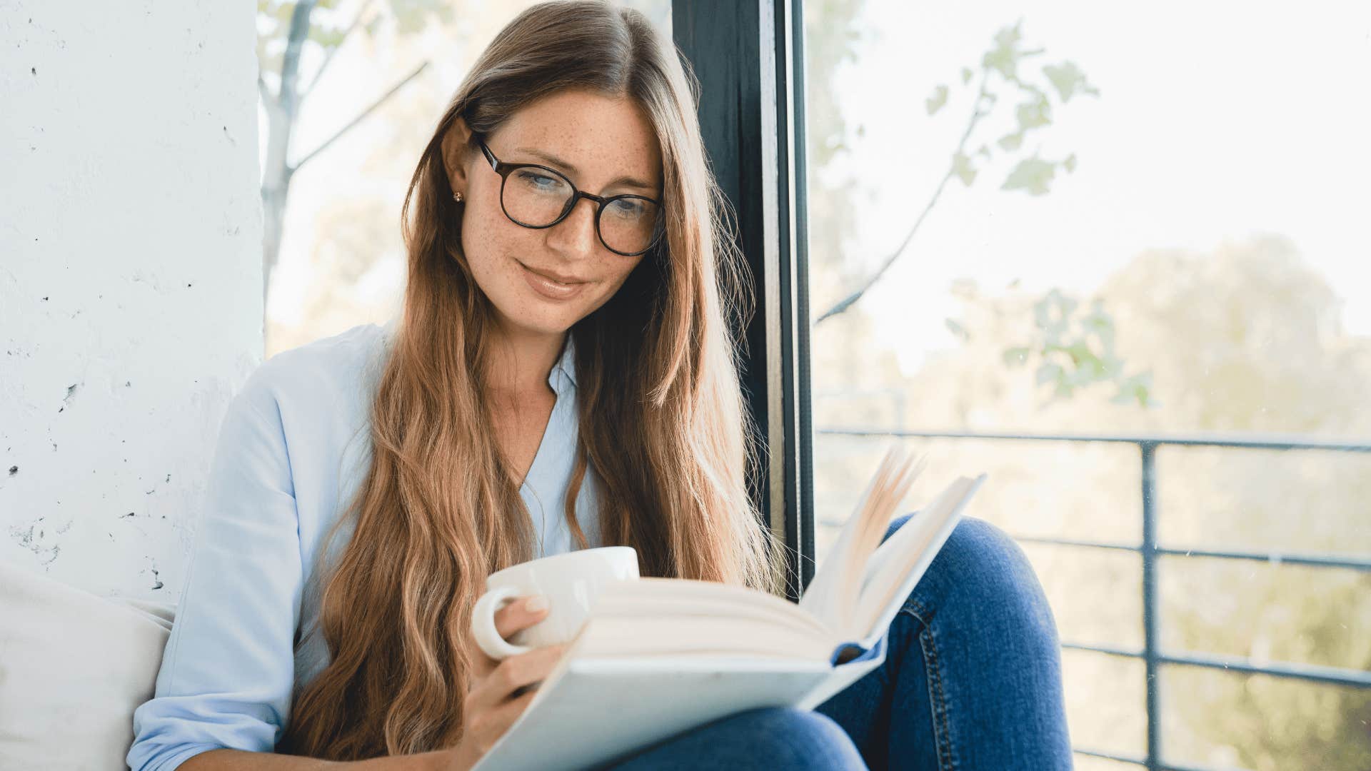 woman in blue shirt and glasses reading for hours without interruption