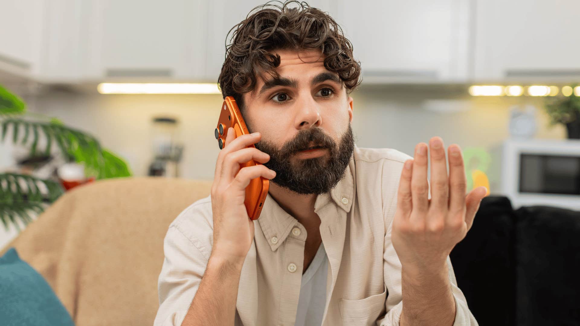 man in white shirt on phone annoyed as he says it's common sense