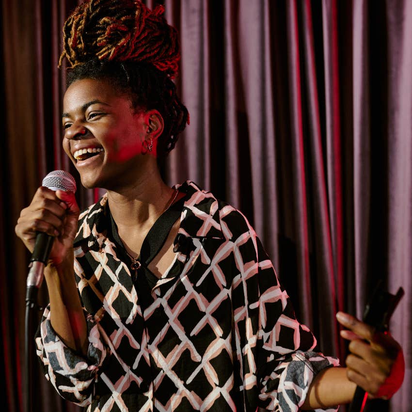 Woman doing comedy and theatre on a stage.