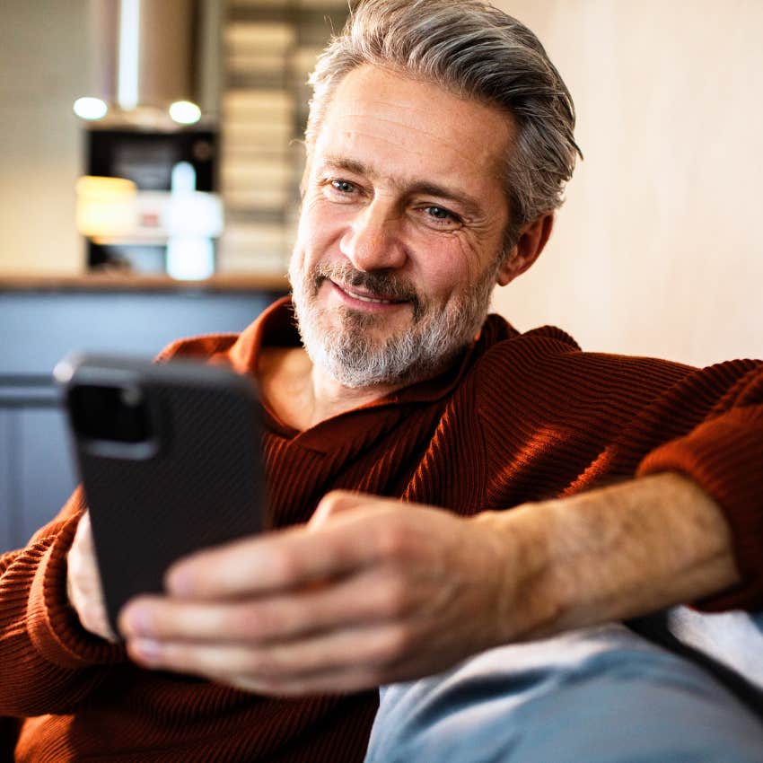 Man using larger text size on their phone at home.