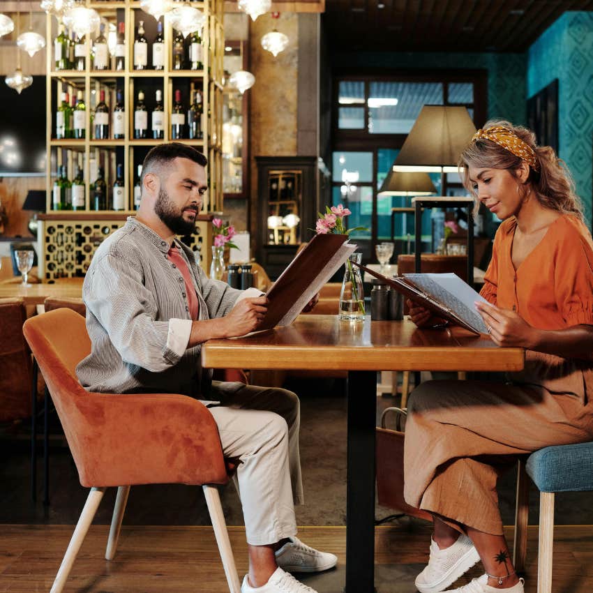 couple checking if there's anything else is on the menu on their date