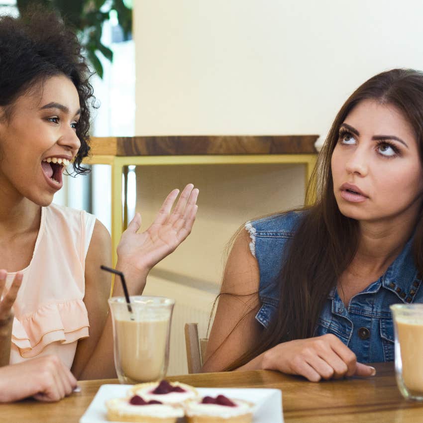 woman who can't be fake rolling her eyes at a friend she doesn't like