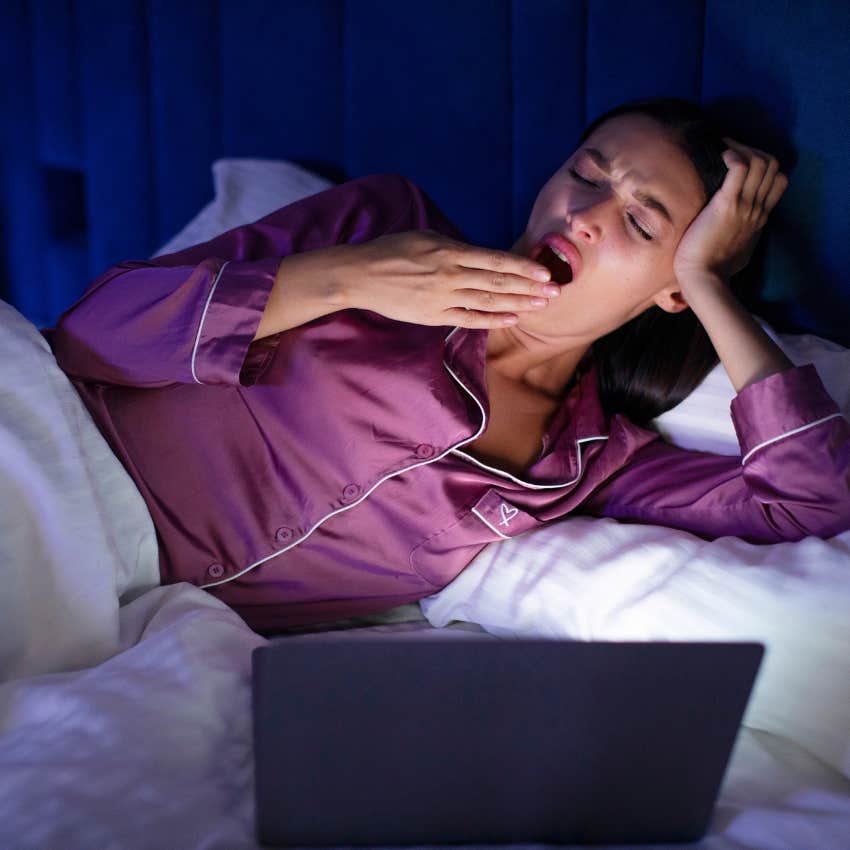 Woman who feels pressured to perform yawning while watching a movie.