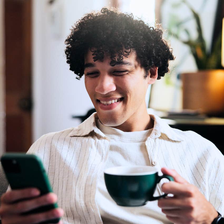 Man curating vibes and using Pinterest on his phone.