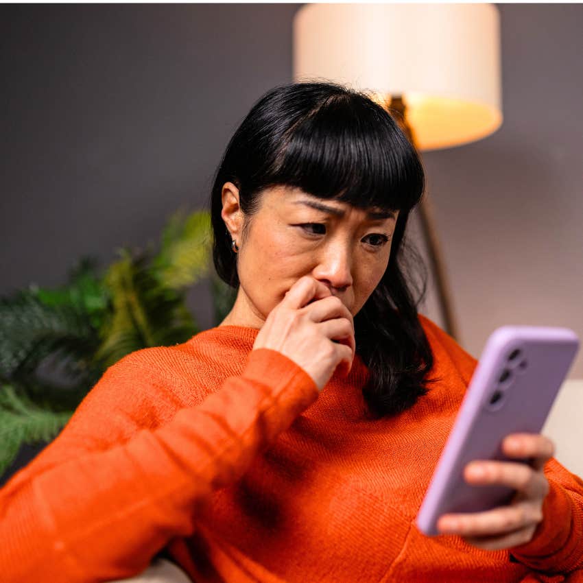 woman dealing with empty promises and unreliability looking at phone