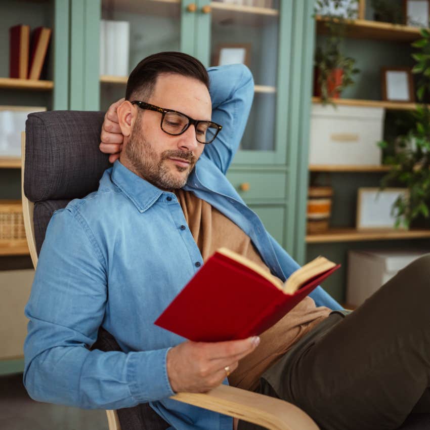 Man reading poetry at home alone.
