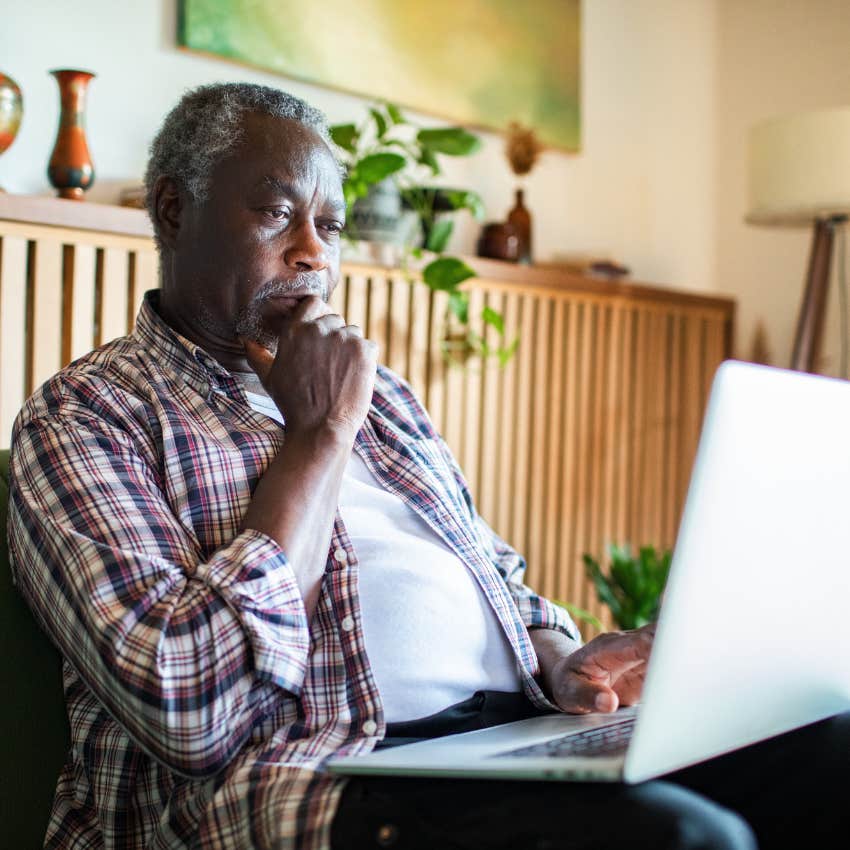 Man researching random topics on his computer at home.