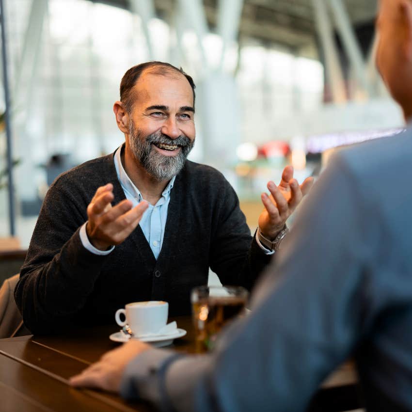 Happy man using reassuring phrases in a conversation.