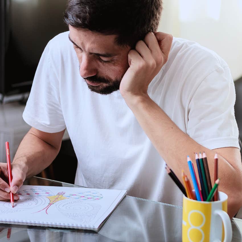 man using adult coloring books for comfort