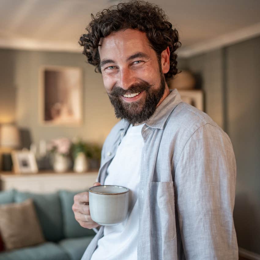 happy man drinking his favorite beverage at home