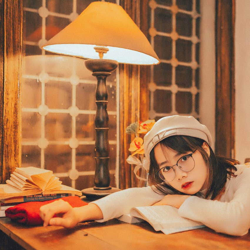 woman at her desk filled with decorations and art