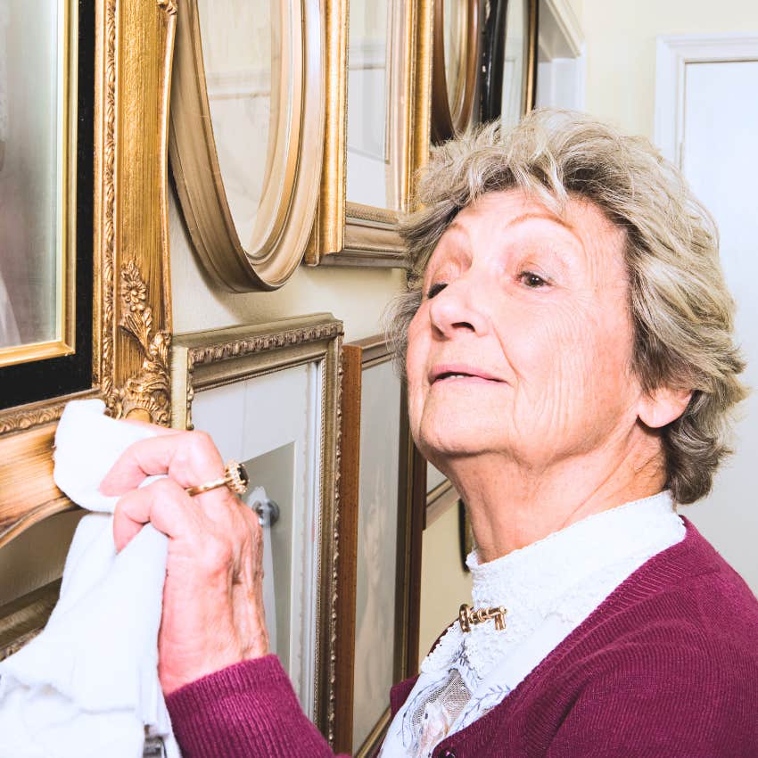 older woman polishing family heirlooms in her living room