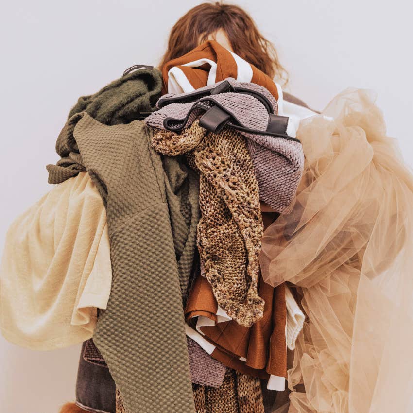 person holding a pile of clothes