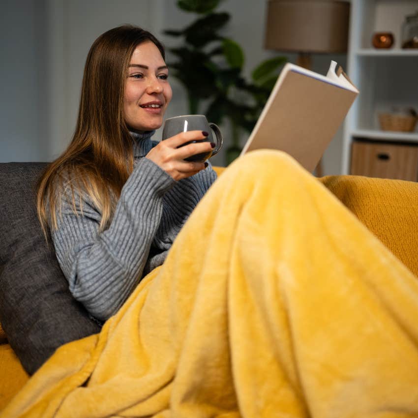introvert woman who prefers quiet evenings and canceled plans reading a book