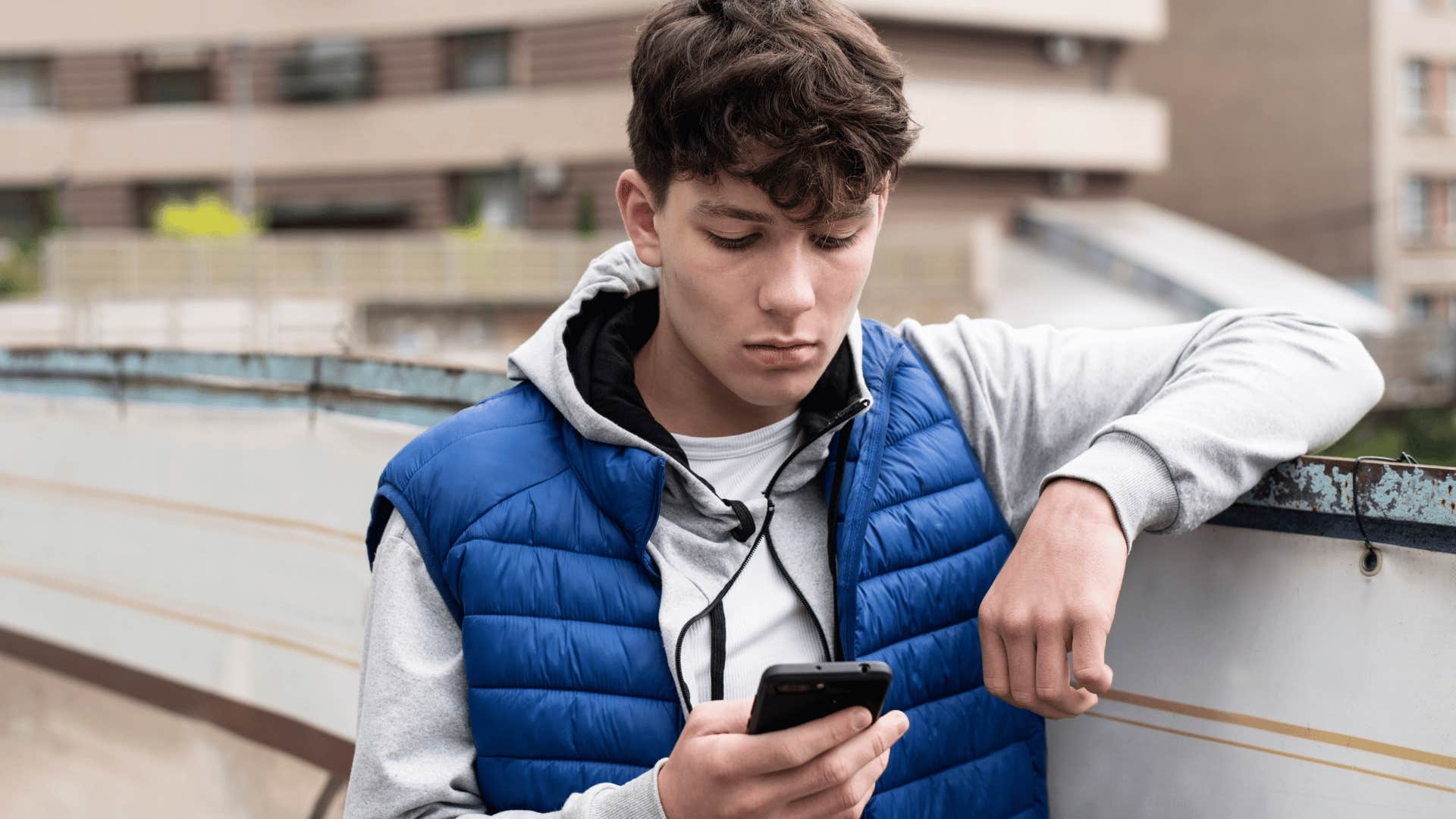 mentally detached young man texting that he doesn't need anybody