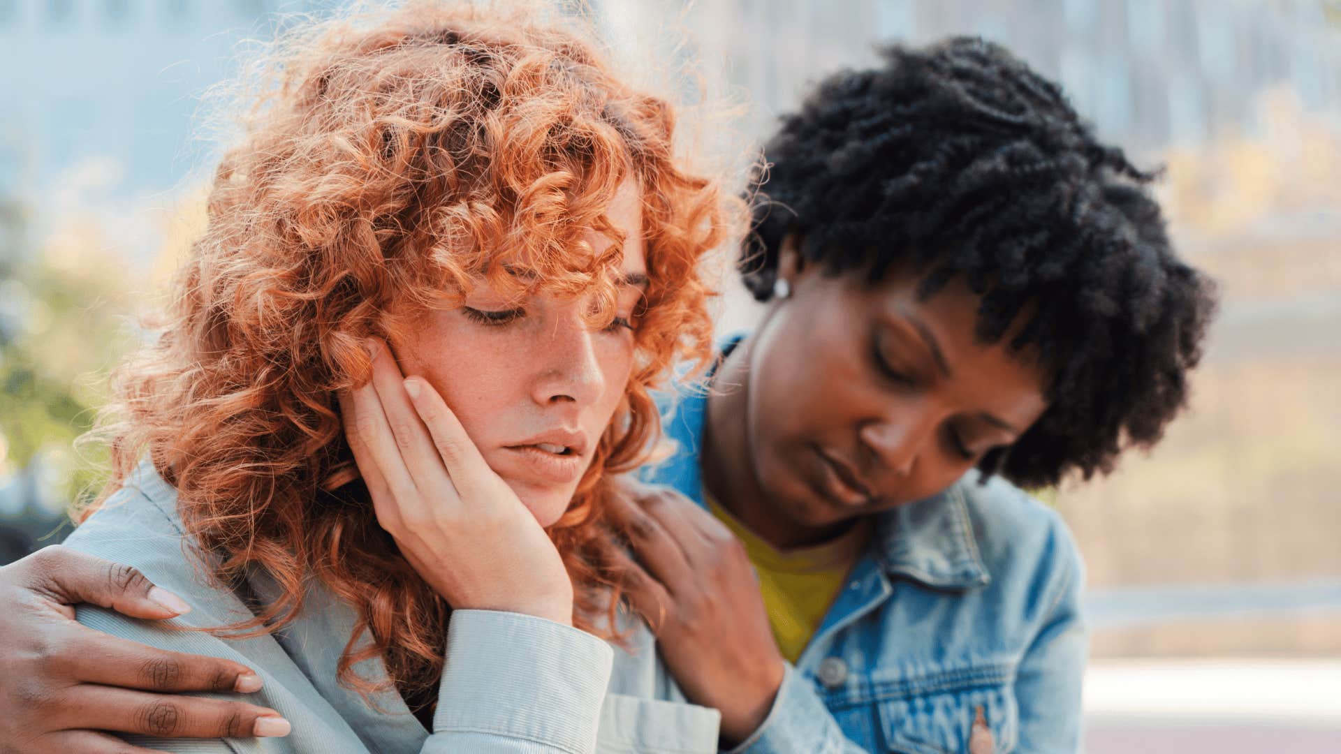woman comforting sad friend telling her i'm just tired