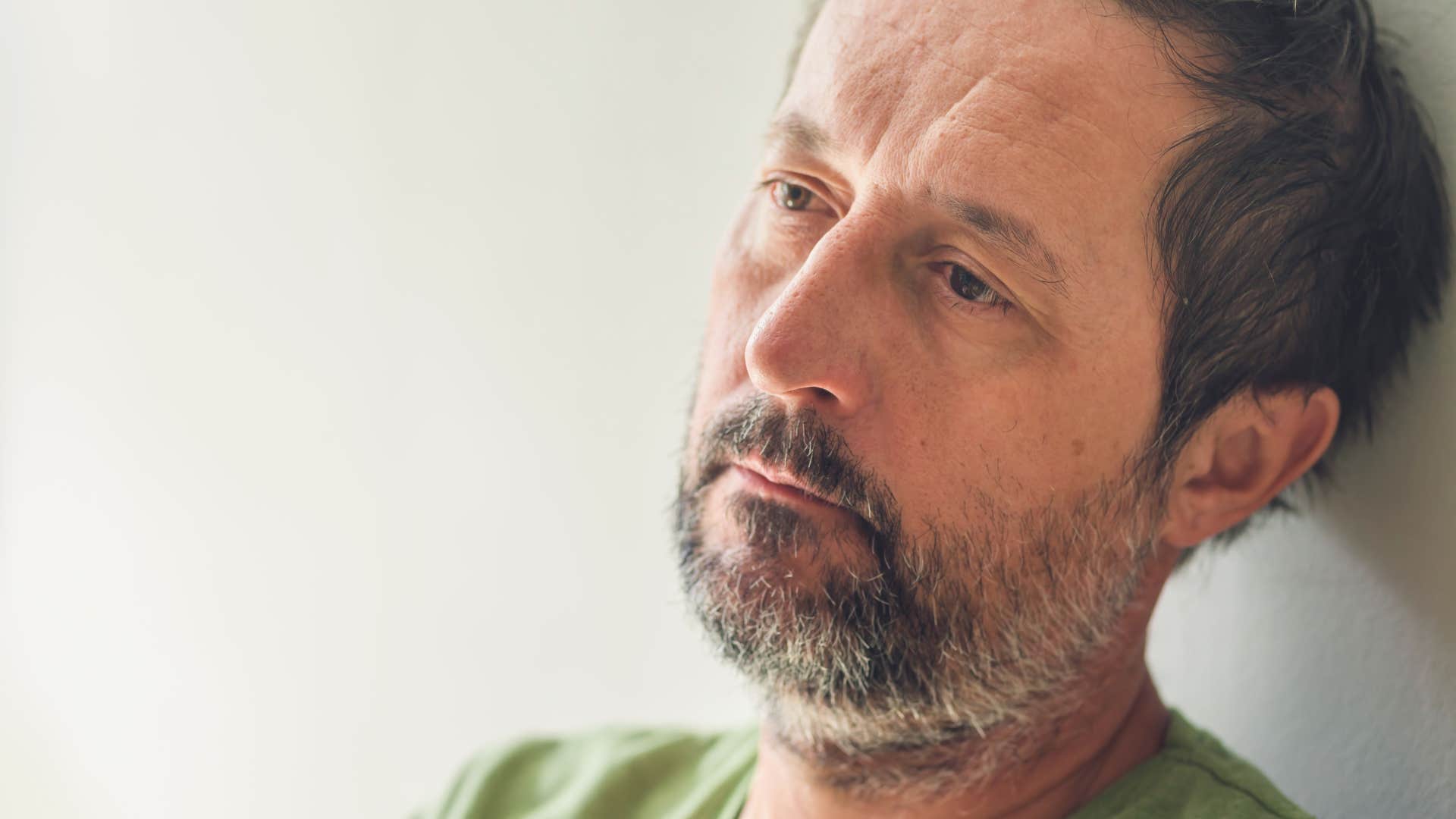 mentally detached man sitting at home saying whatever happens happens