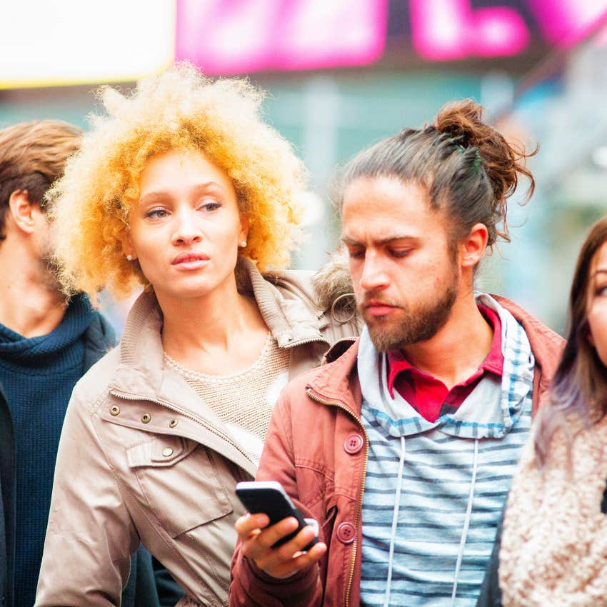 woman wondering if the place she's waiting in line for knows who she is