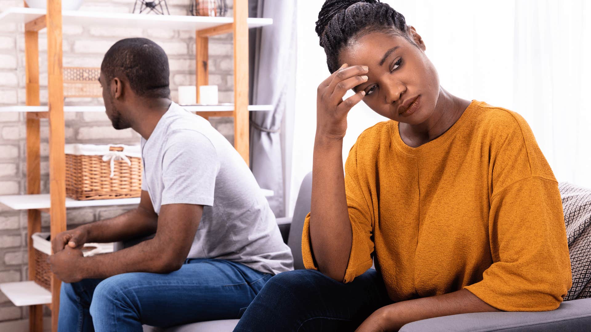 depressed woman sitting next to partner accepting this is her reality