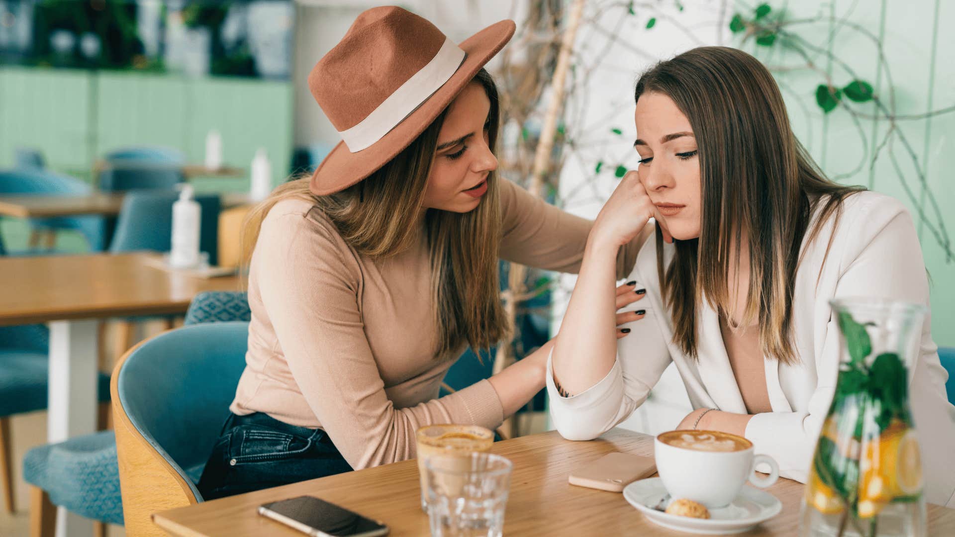 woman comforting friend saying she doesn't feel valued in her relationship