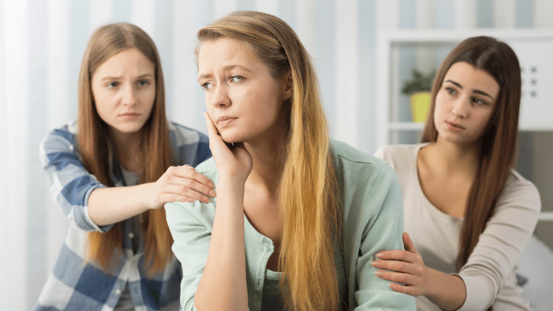 friends comforting woman talking about her sad relationship