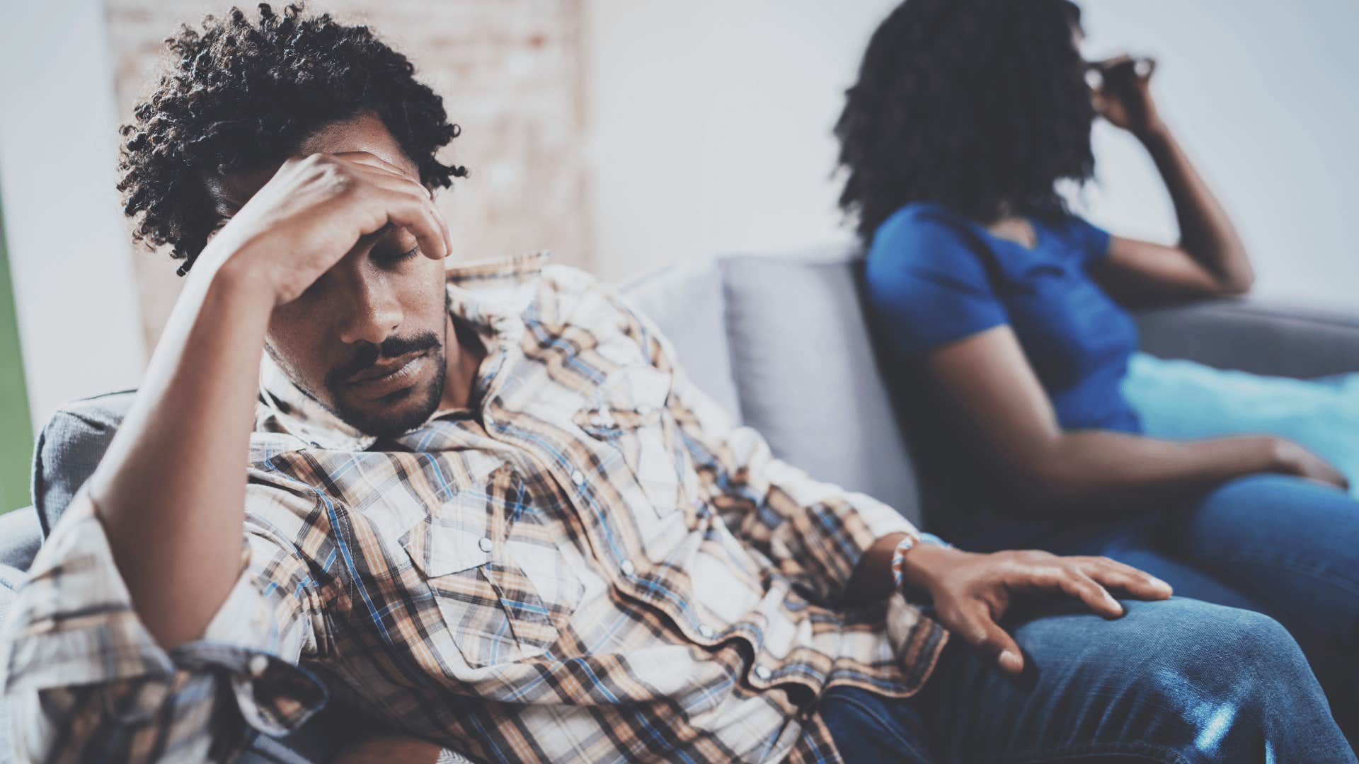 man in a sad relationship turned away from partner he doesn't talk to anymore