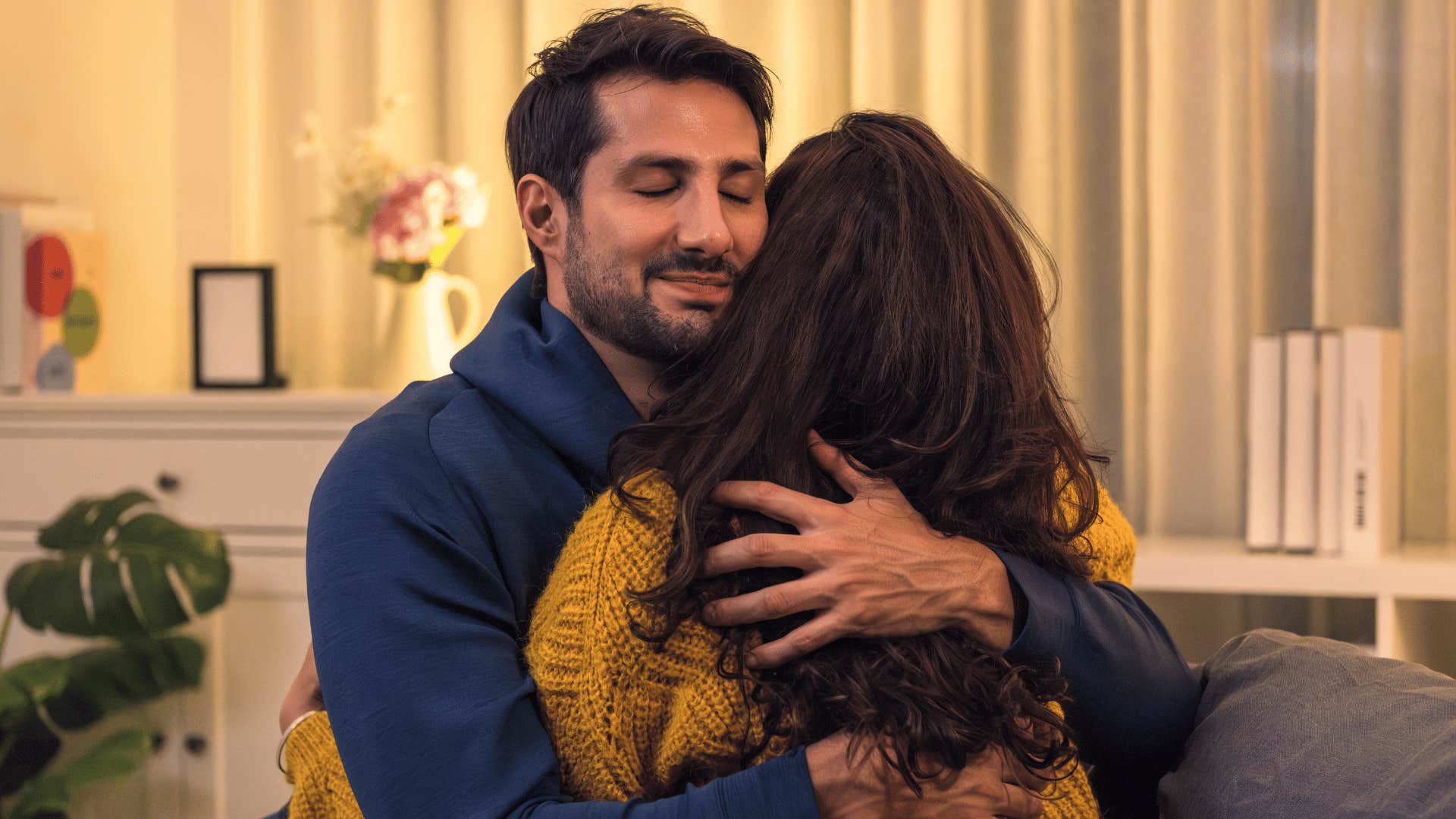authentic man hugging woman and forgiving her