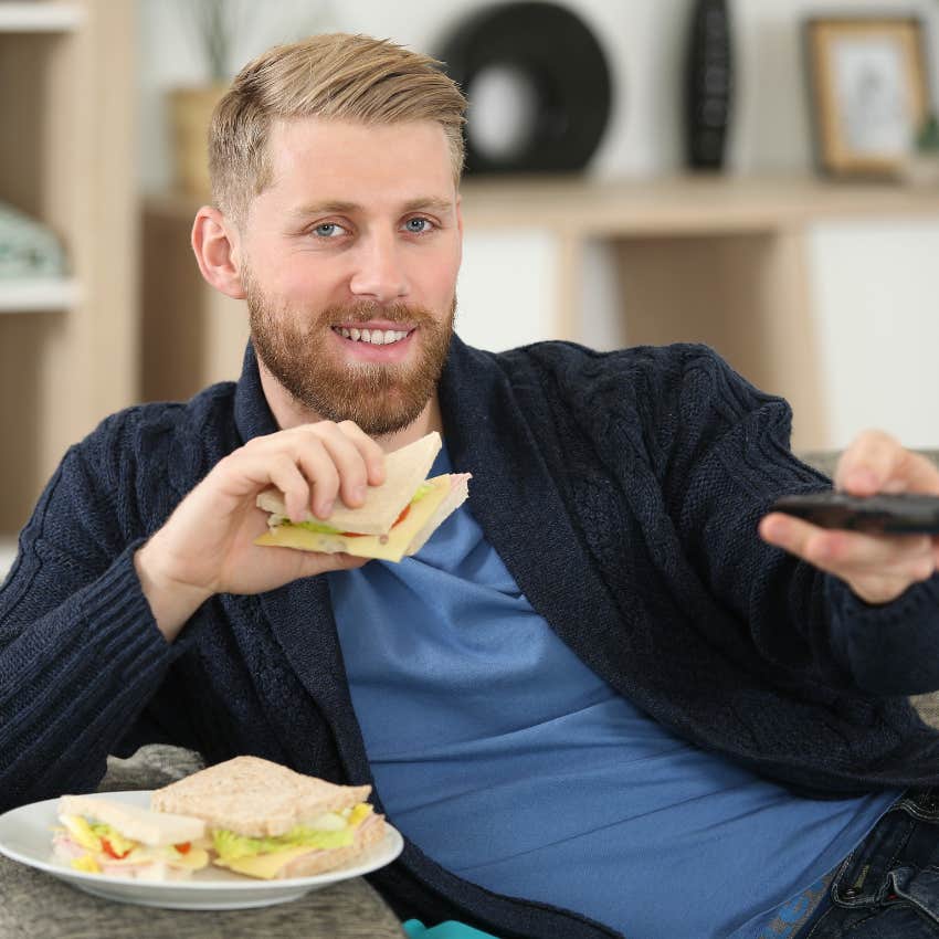 man watching tv and eating pushing responsibilities to later