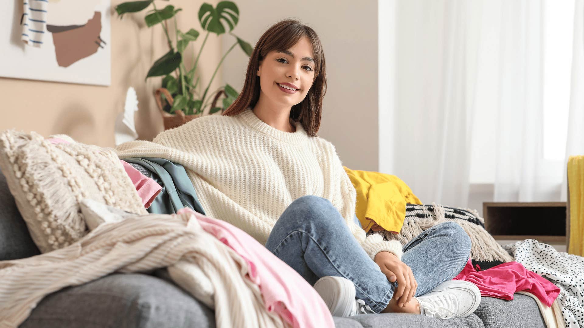 woman piling clothes on a chair