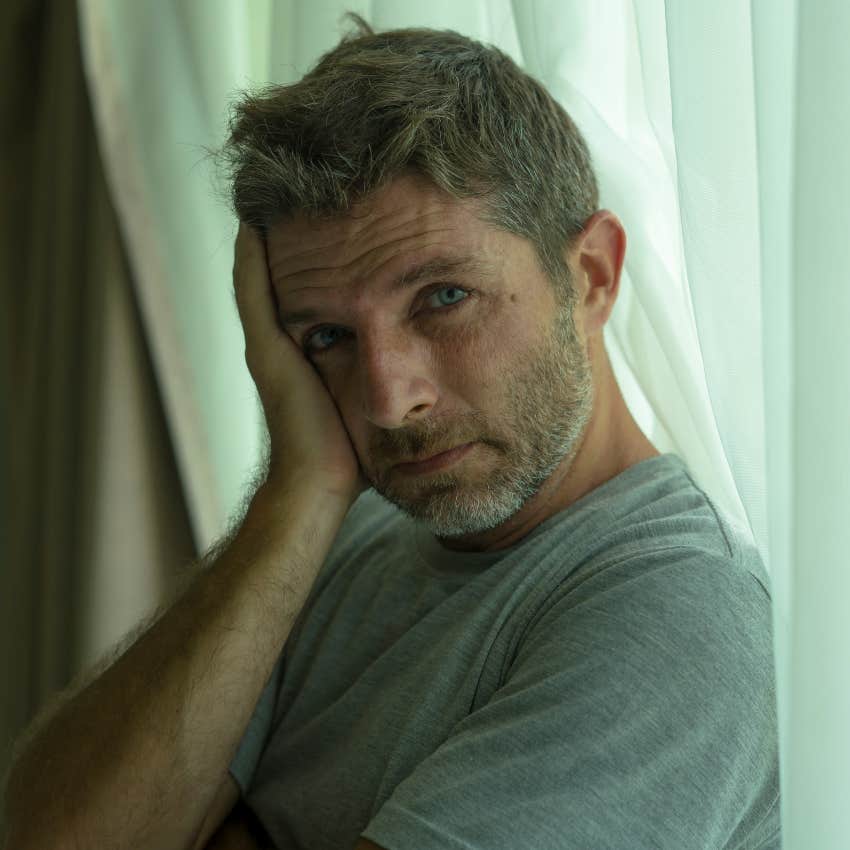 sad man hiding his emotional and mental rage