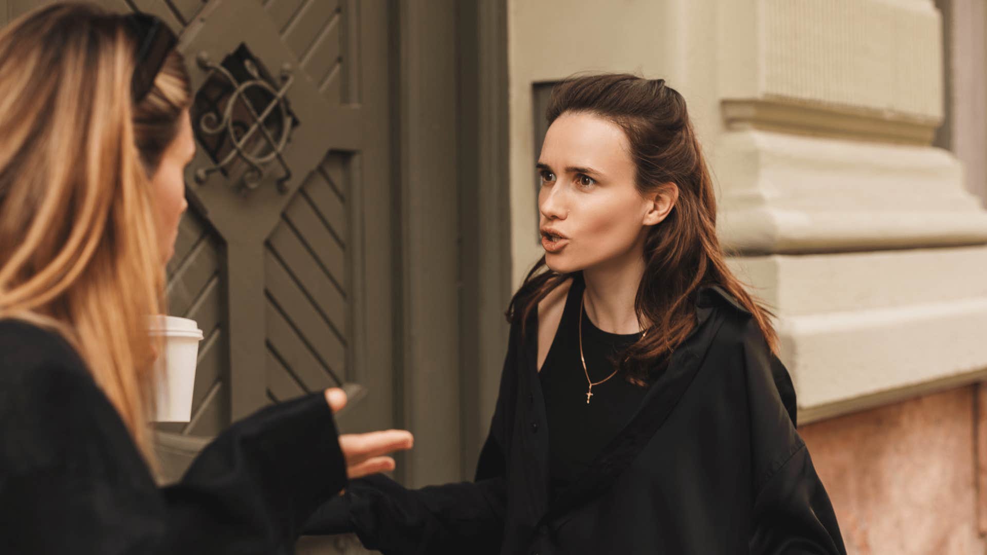 two friends fighting woman telling the other she's embarrassing