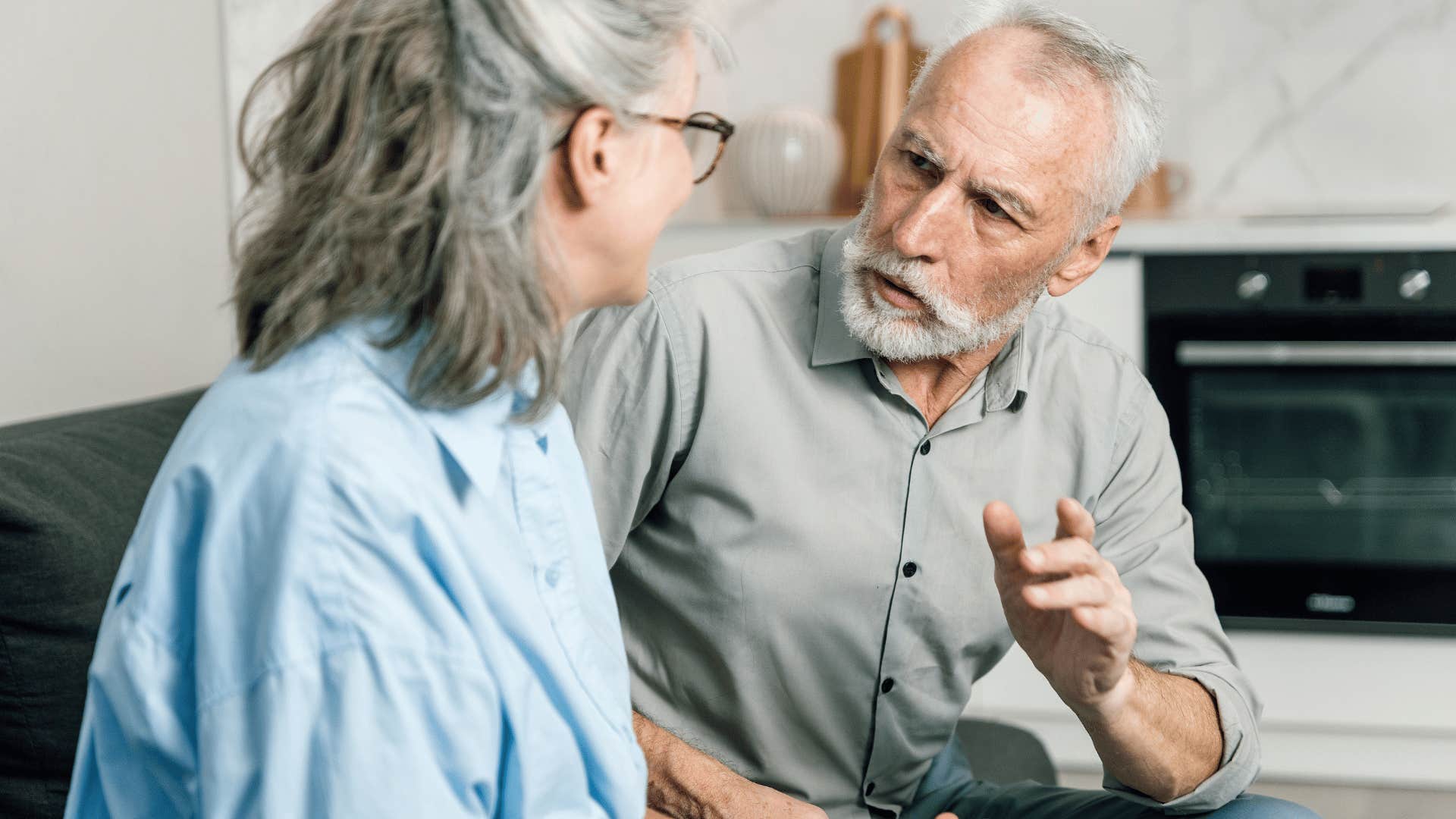 unkind older man speaking down to wife saying you're on your own