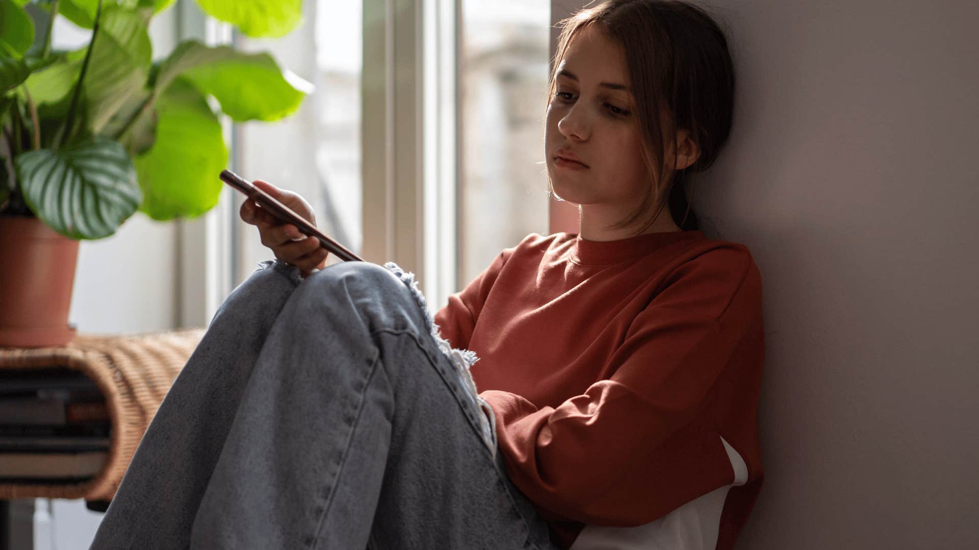 sad young woman texting that she can figure it out on her own