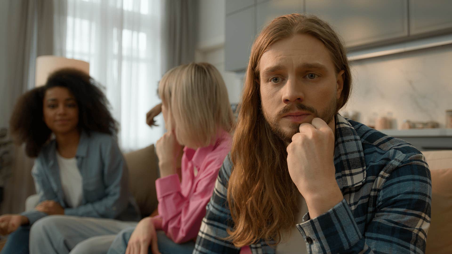 overthinking man feeling lonely among friends