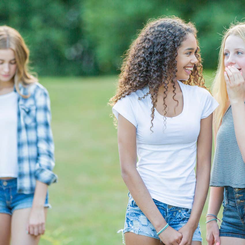 girl being gossiped about and sad about how they describe her