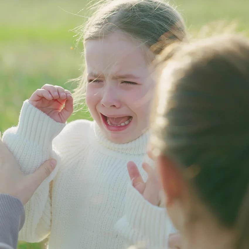 little girl crying parents telling her she has nothing to be sad about