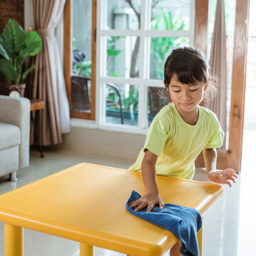 little kid doing household chores around the house