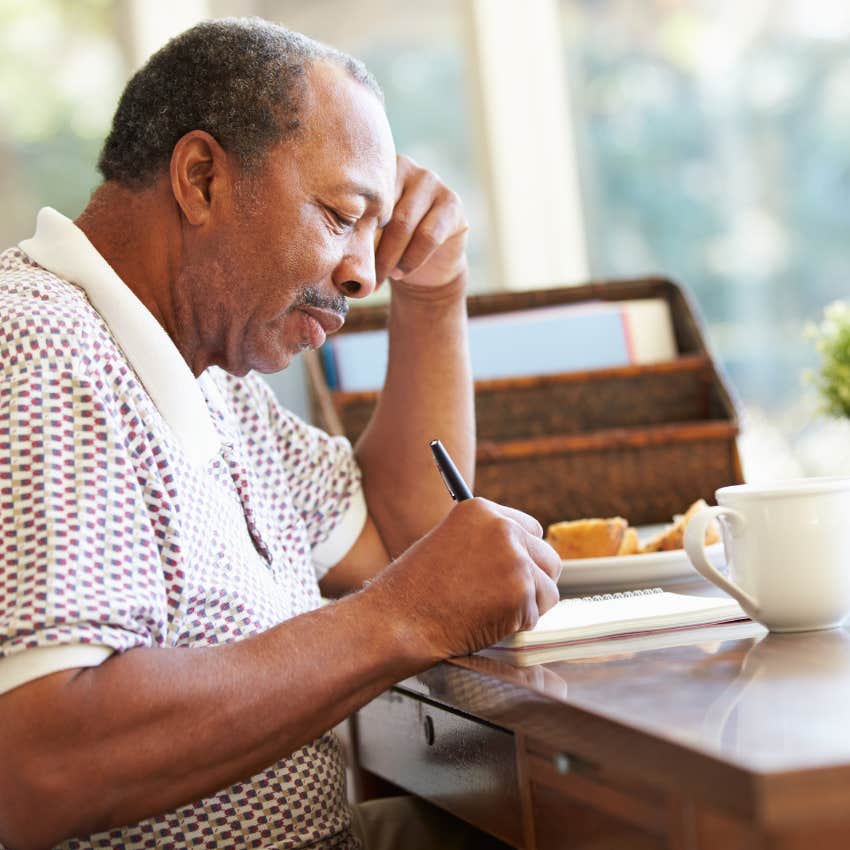 older man keeping a record of his life in a journal