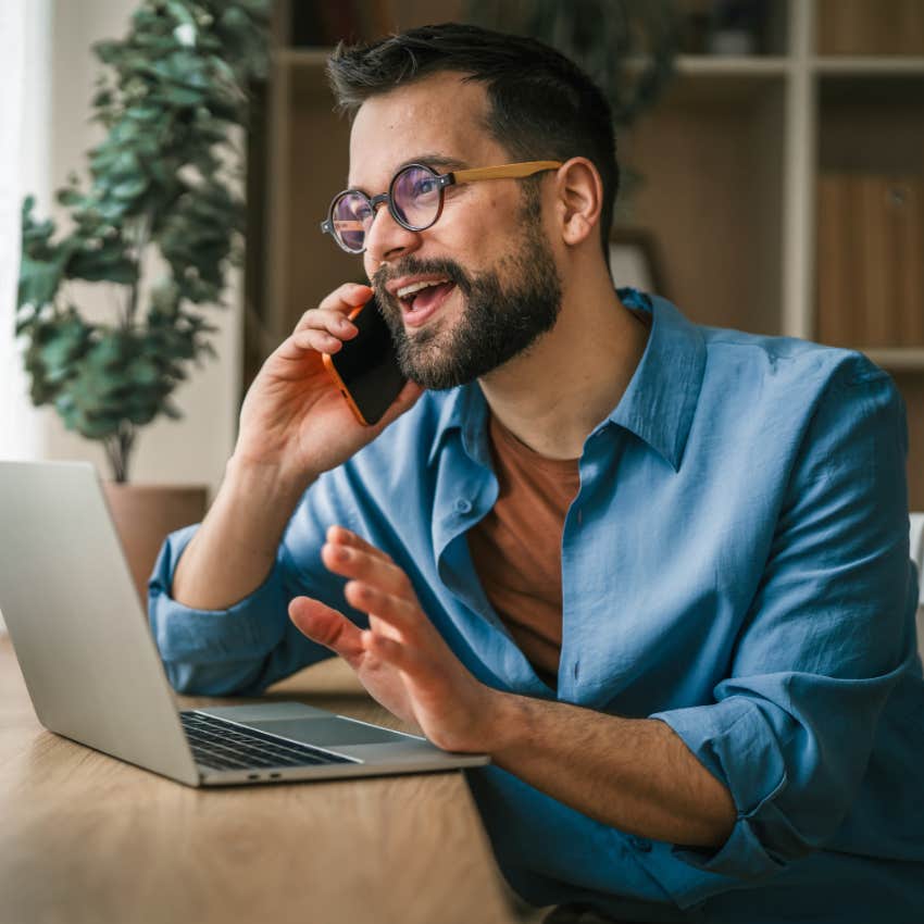 resilient millennial man on the phone and writing on laptop
